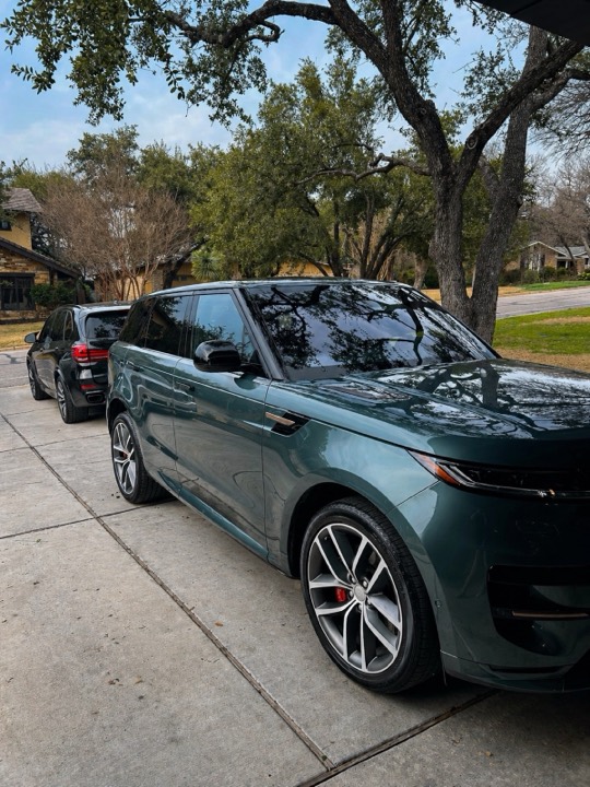 Green Range Rover Sport freshly detailed in a shaded Austin driveway