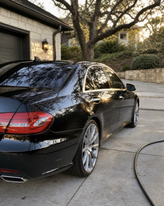 Black luxury sedan with show-ready ceramic coated finish at golden hour, Westlake Hills