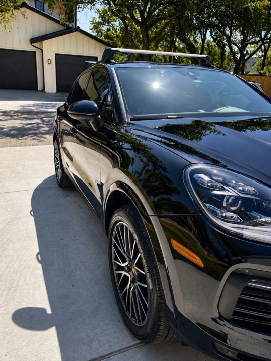 Black Porsche Cayenne with deep ceramic-coated gloss in an Austin driveway